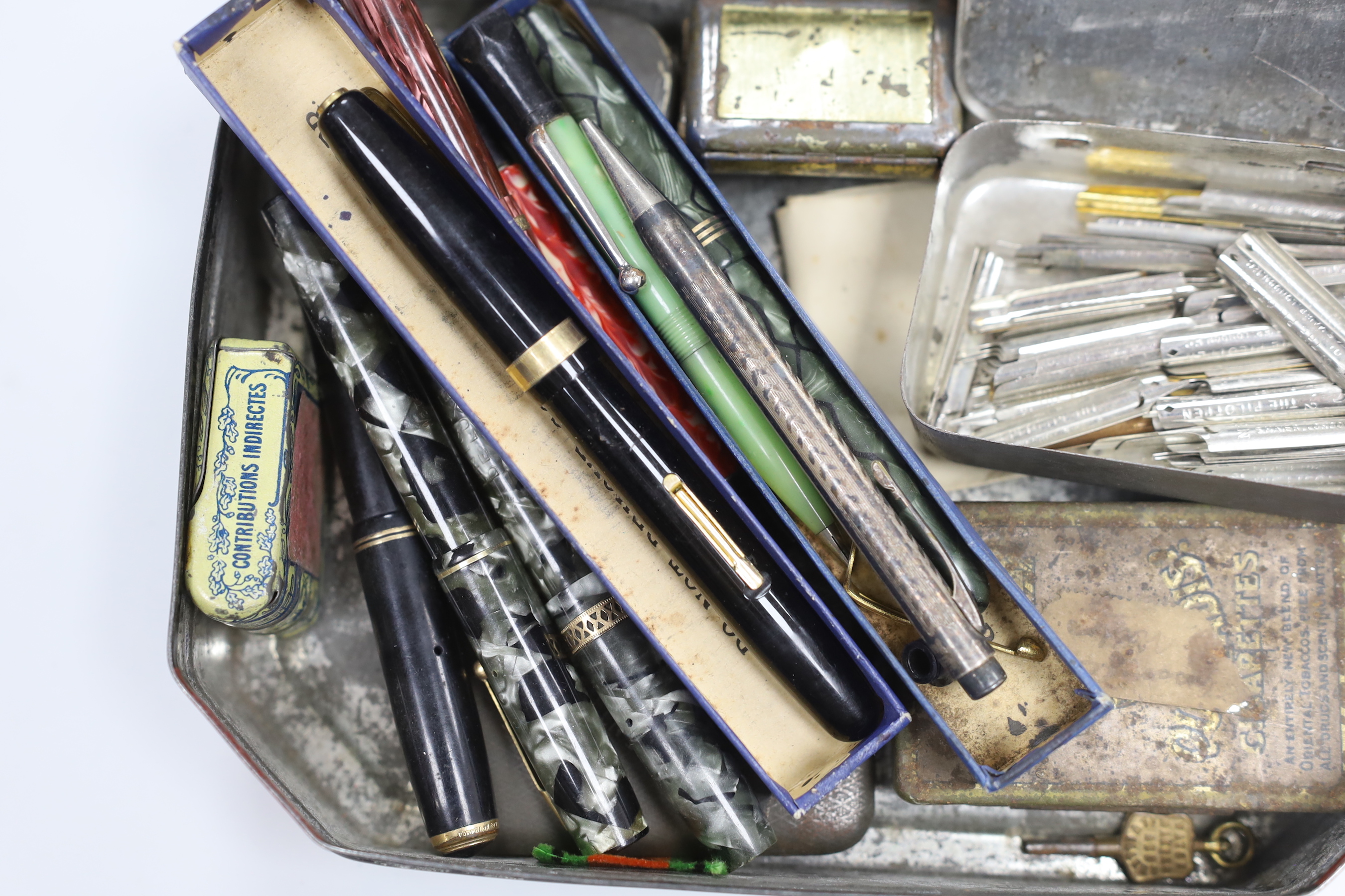 A collection of gold nibbed fountain pens and a collection of nibs